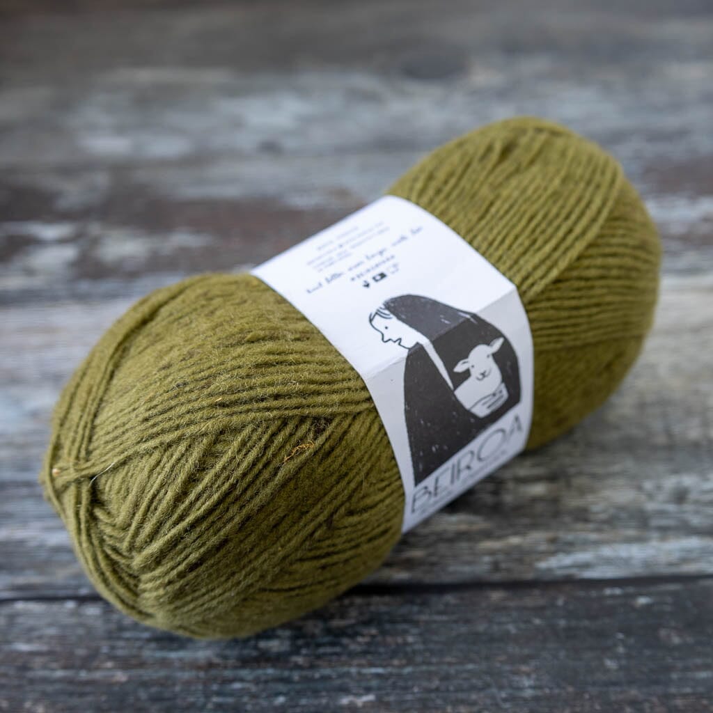khaki ball of yarn on wooden surface with label beiroa