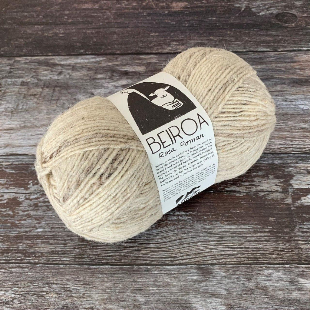 natural ball of yarn on wooden surface with label beiroa