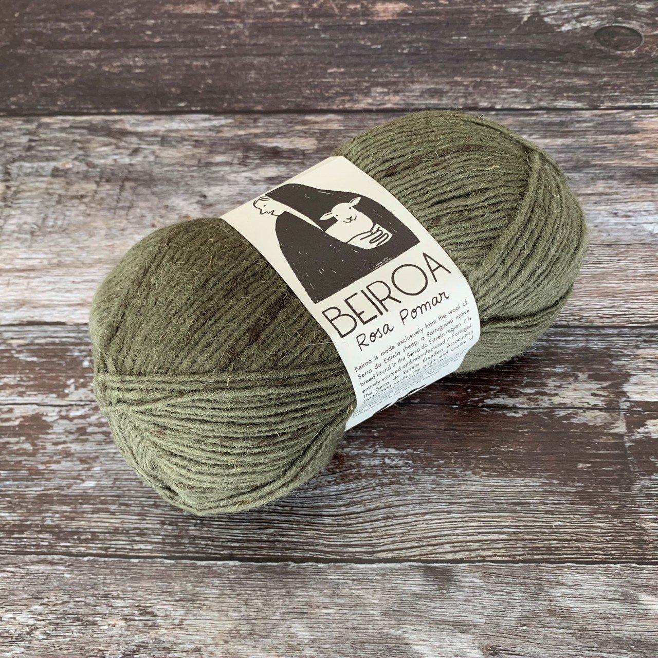 green ball of yarn on wooden surface with label beiroa